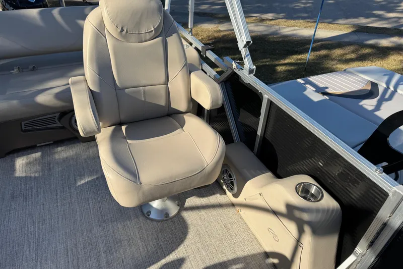 Slide: The Image of 2021 Avalon LSZ 2485 boat interior with beige captain's chair and cup holder. - 16