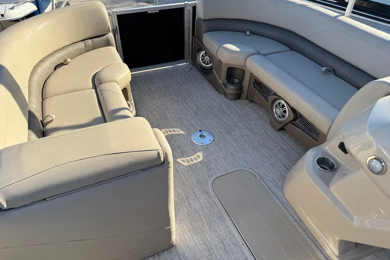 Slide: The Image of Interior of 2021 Avalon LSZ 2485 pontoon boat with beige seating and cup holders. - 21