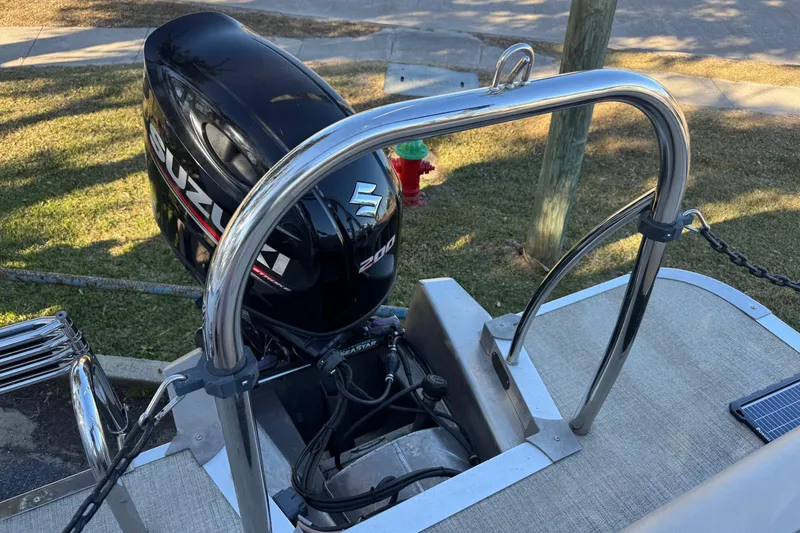 Slide: The Image of 2021 Avalon LSZ 2485 boat with Suzuki 200 outboard motor, docked on grass. - 26