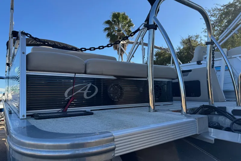 Slide: The Image of 2021 Avalon LSZ 2485 pontoon boat with cushioned seating and sleek design. - 30