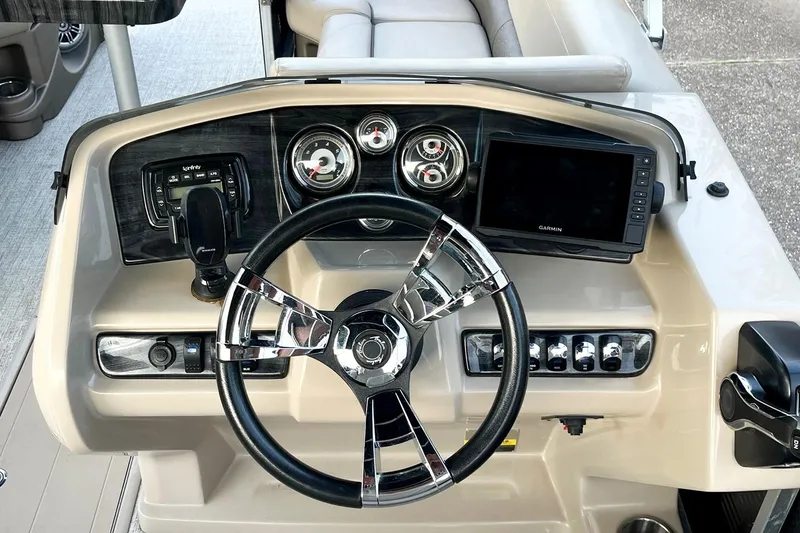 Slide: The Image of 2021 Avalon LSZ 2485 boat dashboard with steering wheel and control panel. - 5