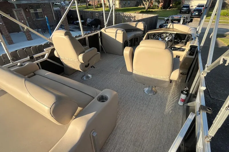 Slide: The Image of 2021 Avalon LSZ 2485 boat with black privacy curtain, outdoor setting. - 7