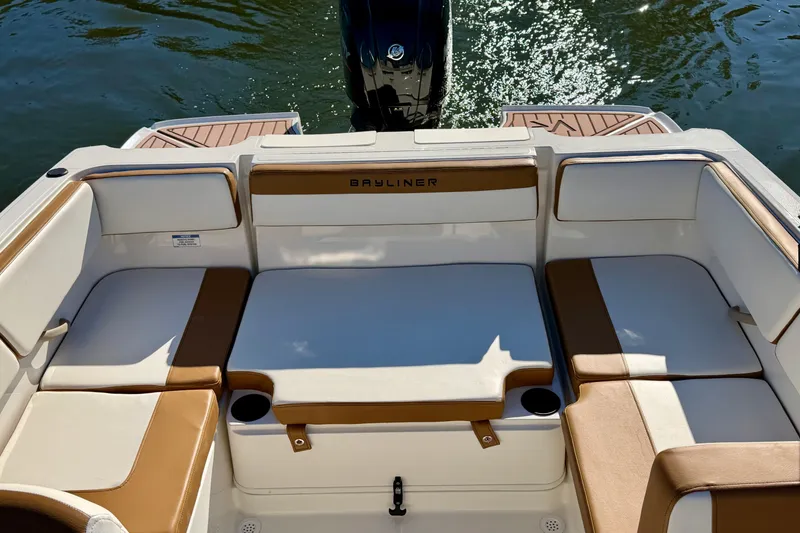 Slide: The Image of 2023 Bayliner VR4 Bowrider OB boat interior with cushioned seating and cup holders. - 13