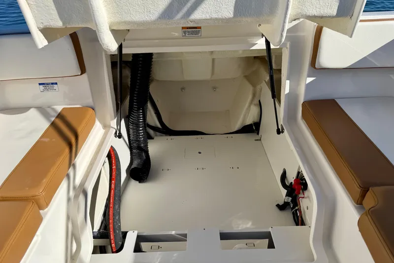 Slide: The Image of 2023 Bayliner VR4 Bowrider OB storage compartment with open hatch and seating. - 21