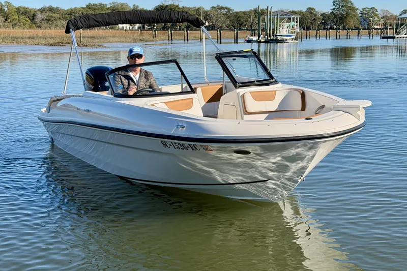 Slide: The Image of 2023 Bayliner VR4 Bowrider OB on calm water, featuring sleek design and spacious seating. - 4