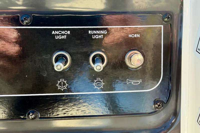 Slide: The Image of Control panel of 2023 Bayliner VR4 Bowrider OB with switches for anchor light, running light, and horn. - 9