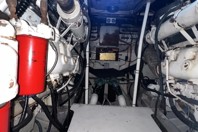 Slide: The Image of Engine room of a 1980 Bertram 42 Convertible boat, showcasing mechanical components. - 14