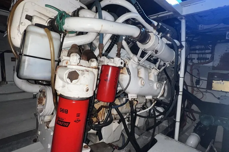 Slide: The Image of Engine room of a 1980 Bertram 42 Convertible boat, featuring mechanical components and filters. - 15