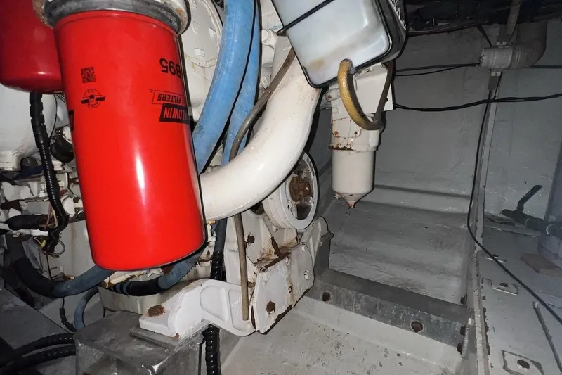 Slide: The Image of Engine room of 1980 Bertram 42 Convertible with visible filters and hoses. - 17