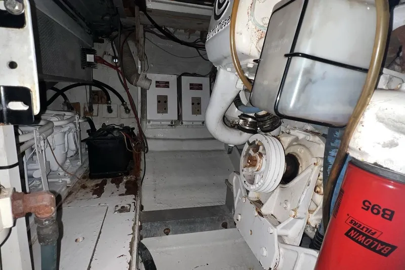 Slide: The Image of Engine room of a 1980 Bertram 42 Convertible boat, showcasing mechanical components. - 18