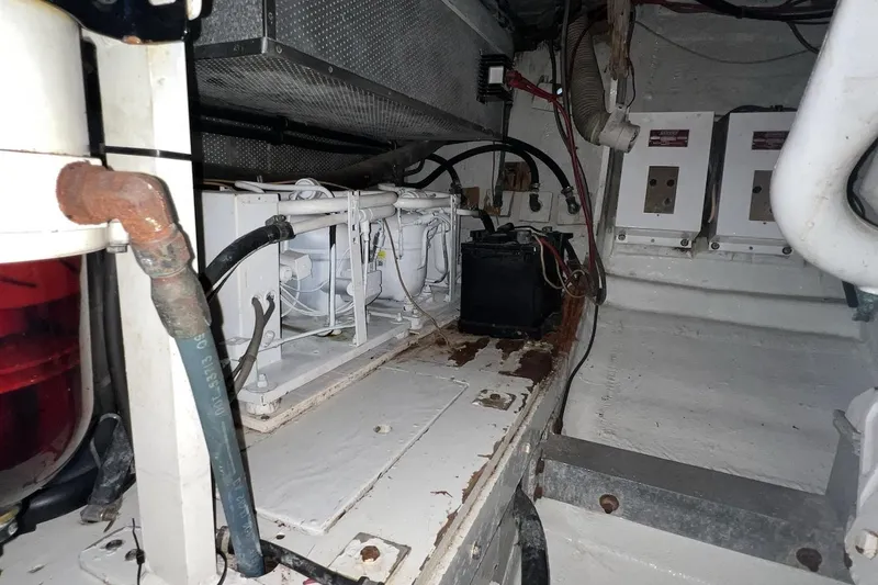 Slide: The Image of Engine room of a 1980 Bertram 42 Convertible boat, showing mechanical components and wiring. - 19