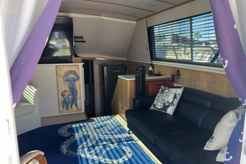 Slide: The Image of Interior of 1986 Bertram 42 Convertible yacht with cozy seating and nautical decor. - 6