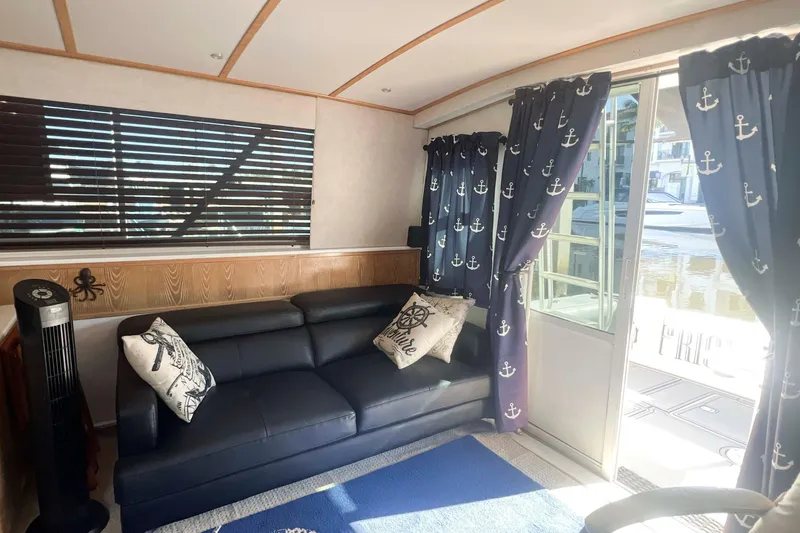 Slide: The Image of Interior of 1986 Bertram 42 Convertible yacht with nautical-themed decor and comfortable seating. - 8