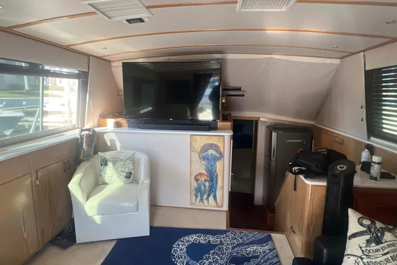 Slide: The Image of Interior of a 1986 Bertram 42 Convertible yacht with modern amenities and nautical decor. - 9