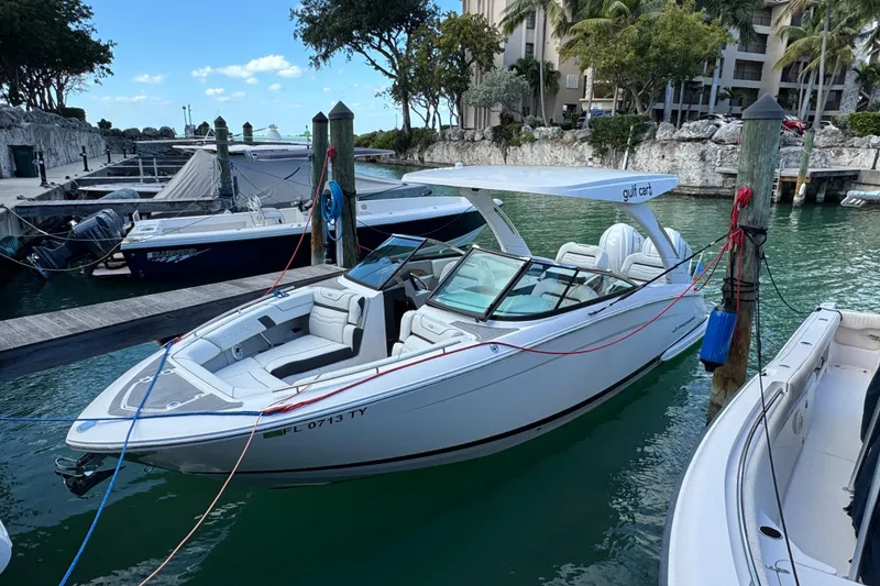 The Image of 2024 Regal LX9 boat docked in a marina, featuring sleek design and modern amenities. - 0