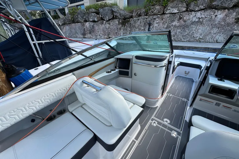Slide: The Image of 2024 Regal LX9 boat interior with sleek white seating and modern dashboard design. - 14