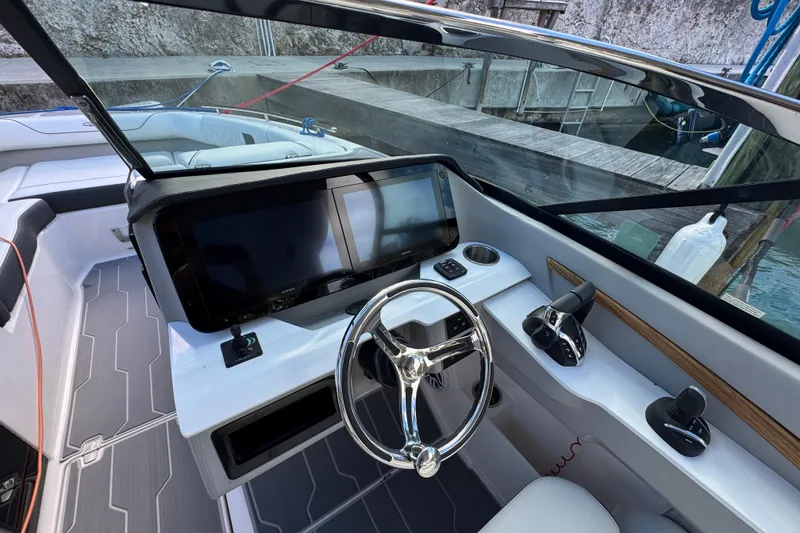Slide: The Image of 2024 Regal LX9 boat cockpit with modern steering and navigation controls. - 16