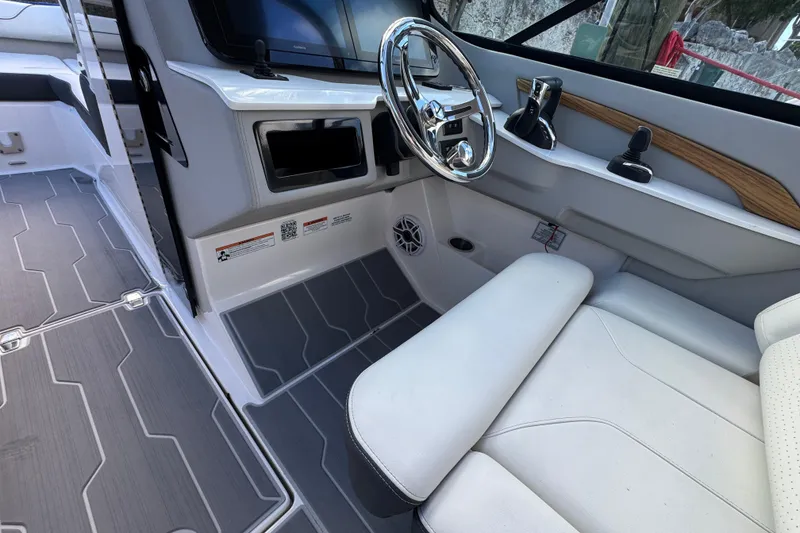 Slide: The Image of 2024 Regal LX9 boat interior with steering wheel and modern controls. - 18