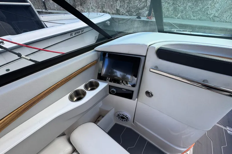 Slide: The Image of Interior of 2024 Regal LX9 boat with modern dashboard and cup holders. - 19