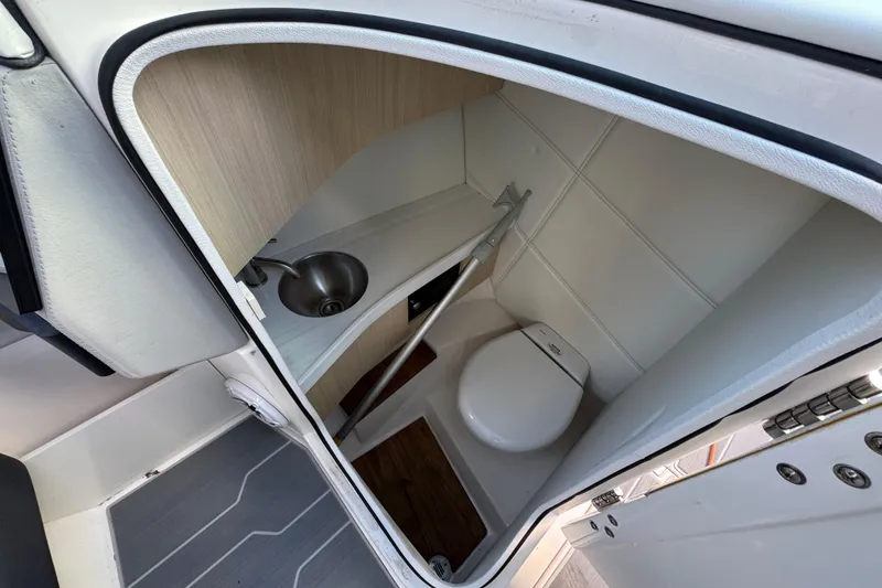 Slide: The Image of 2024 Regal LX9 boat interior bathroom with compact sink and toilet. - 20