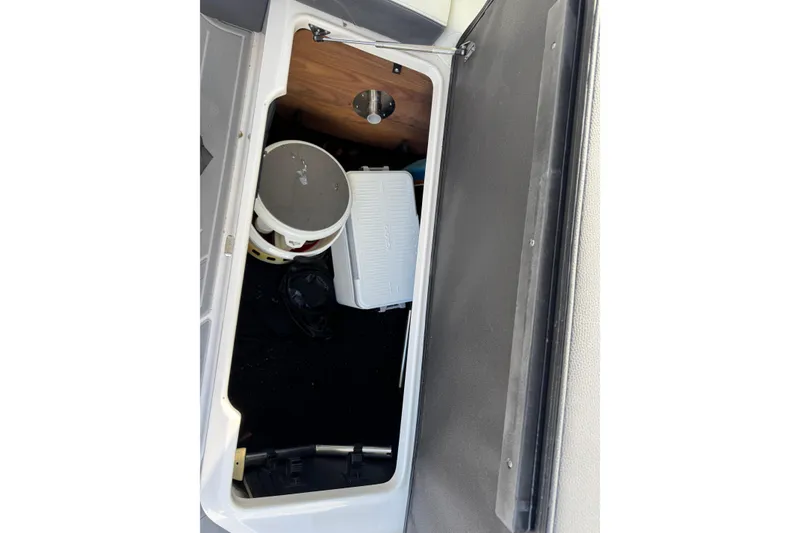 Slide: The Image of 2024 Regal LX9 storage compartment with cooler and bucket inside. - 21