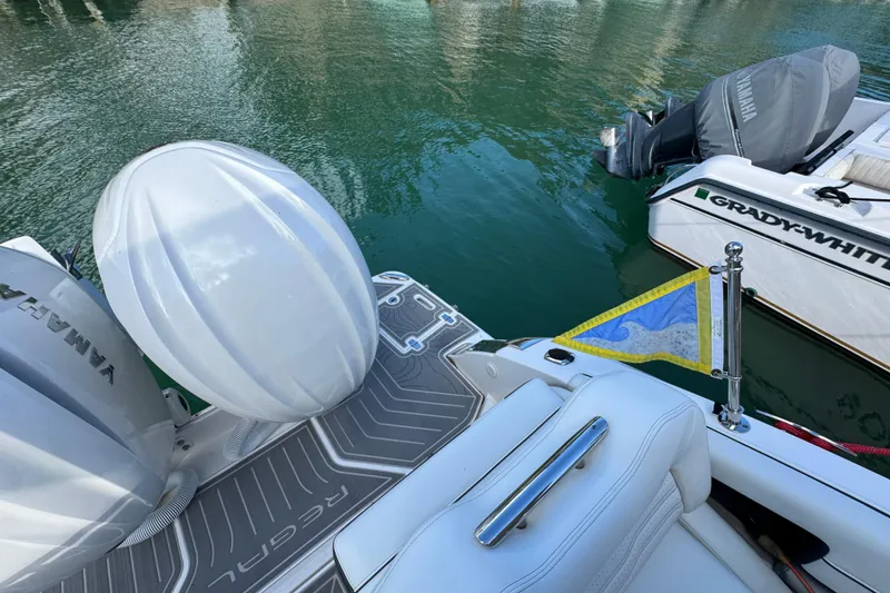 Slide: The Image of 2024 Regal LX9 boat with Yamaha engine, docked beside Grady-White, on calm water. - 8