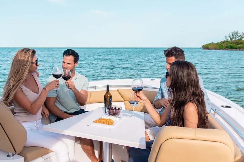Slide: The Image of Manufacturer Provided Image: Group enjoying wine on a 2025 Sportsman Heritage 261 Center Console boat. - 5
