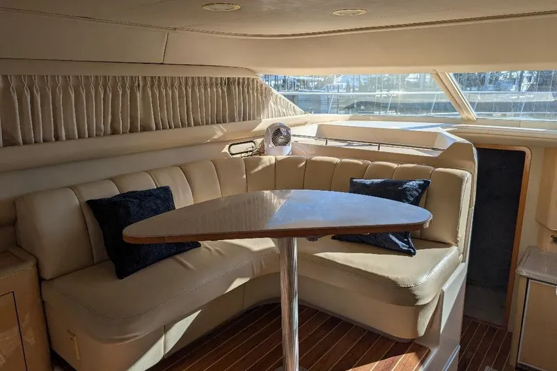 Slide: The Image of Luxurious interior of 2000 Sea Ray 420 Aft Cabin yacht with plush seating and table. - 10