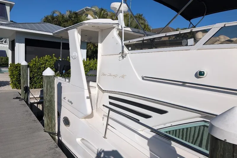 Slide: The Image of 2000 Sea Ray 420 Aft Cabin yacht docked, featuring sleek design and spacious deck. - 4