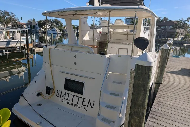 Slide: The Image of 2000 Sea Ray 420 Aft Cabin yacht docked in a serene marina setting. - 5