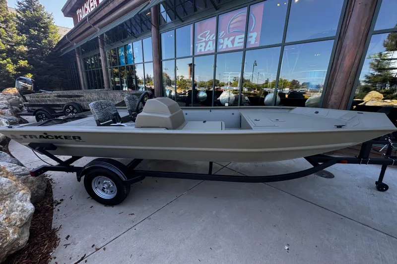 The Image of 2026 Tracker Grizzly 1754 SC boat displayed outside a showroom. - 0