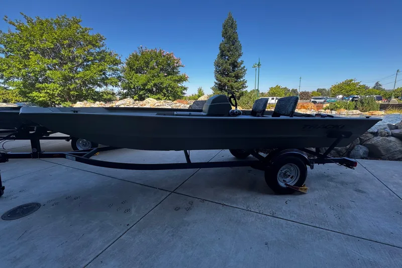 Slide: The Image of 2026 Tracker Grizzly 1754 SC boat on trailer, parked outdoors. - 3
