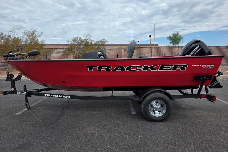 The Image of 2026 Tracker Pro Guide V-16 SC boat in vibrant red on a trailer. - 0