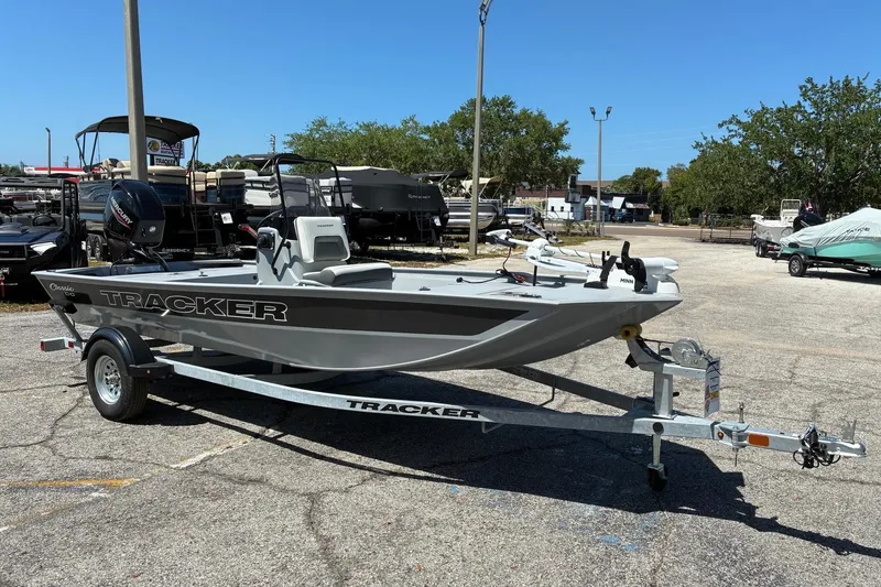 Slide: The Image of 2026 Tracker Bass Tracker Classic CC boat on trailer in outdoor lot. - 2