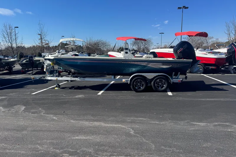 The Image of 2026 Ranger RB200 boat on trailer in parking lot, surrounded by other boats. - 0