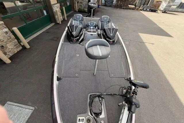 Slide: The Image of 2026 Ranger Z519R fishing boat with dual seats and trolling motor, parked outdoors. - 82