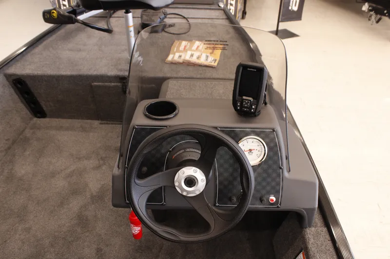 Slide: The Image of 2026 Tracker Bass Tracker Classic XL boat dashboard with steering wheel and navigation system. - 14
