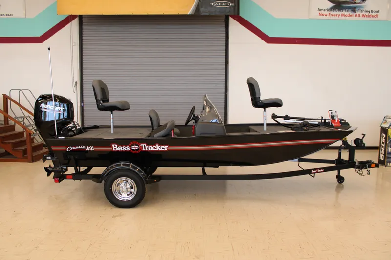 Slide: The Image of 2026 Tracker Bass Tracker Classic XL fishing boat on display indoors. - 15
