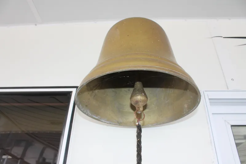 Slide: The Image of Large brass bell on 2008 Sharpe 105 Custom Houseboat, mounted on white wall. - 10