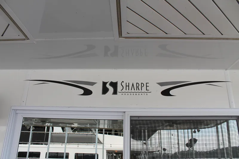Slide: The Image of 2008 Sharpe 105 Custom Houseboat exterior with logo and design details. - 13