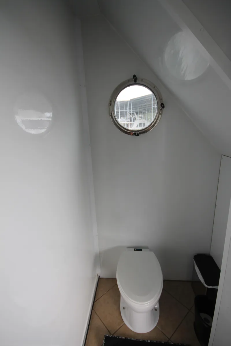 Slide: The Image of Bathroom interior of 2008 Sharpe 105 Custom Houseboat with porthole window. - 22