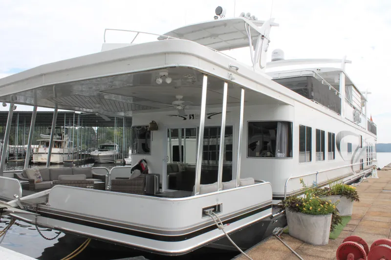 Slide: The Image of 2008 Sharpe 105 Custom Houseboat docked, featuring spacious deck and modern design. - 3