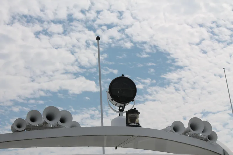 Slide: The Image of Rooftop of 2008 Sharpe 105 Custom Houseboat with horns and spotlight against cloudy sky. - 38