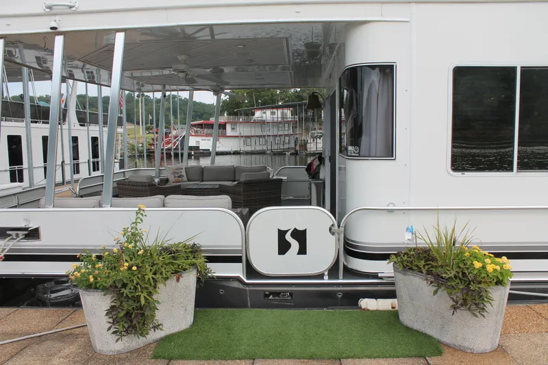Slide: The Image of 2008 Sharpe 105 Custom Houseboat with outdoor seating and decorative plants. - 4