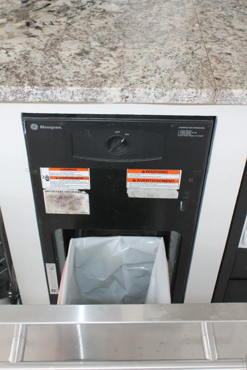 Slide: The Image of Built-in trash compactor on 2008 Sharpe 105 Custom Houseboat with granite countertop. - 48