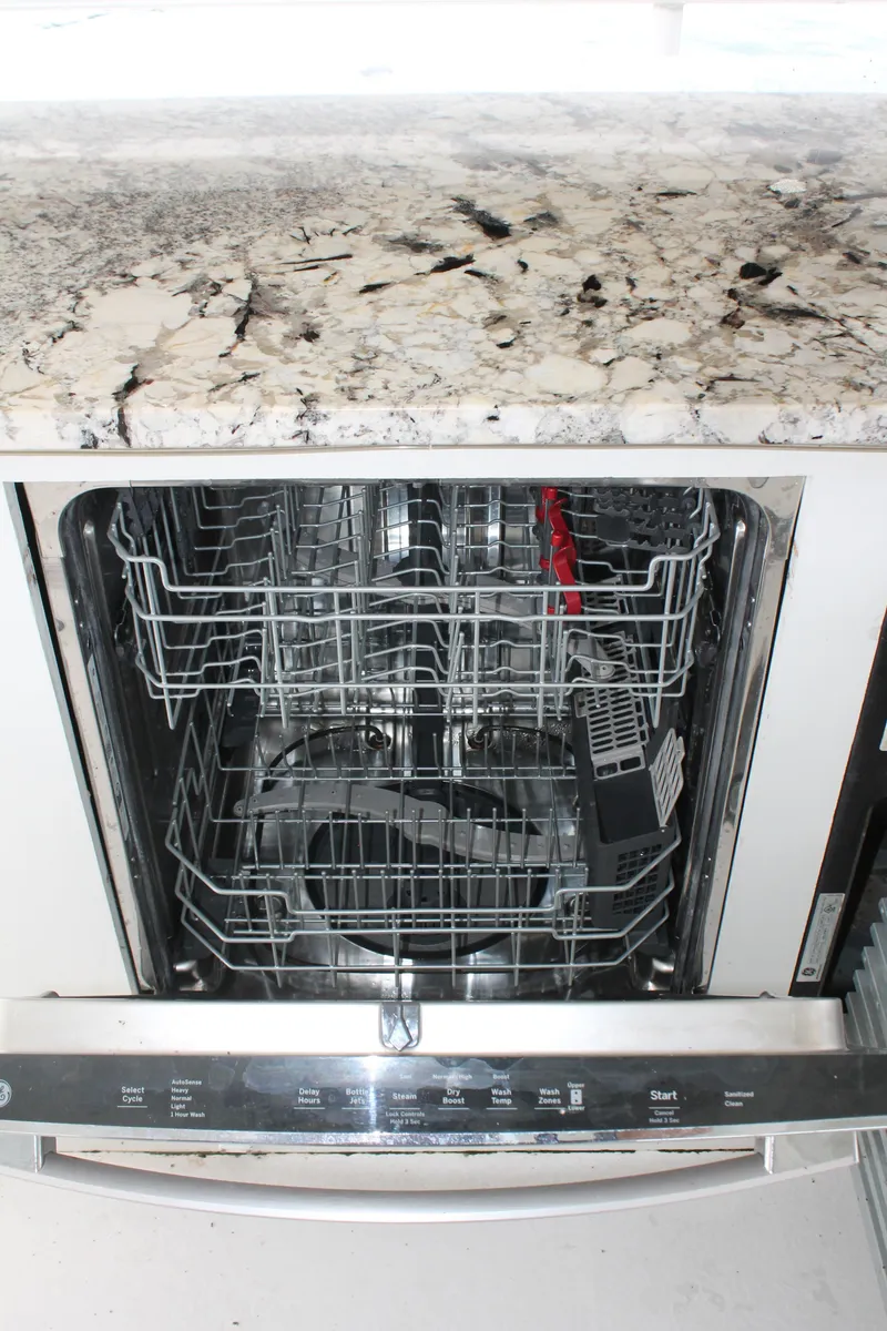 Slide: The Image of Open dishwasher with granite countertop on a 2008 Sharpe 105 Custom Houseboat. - 49
