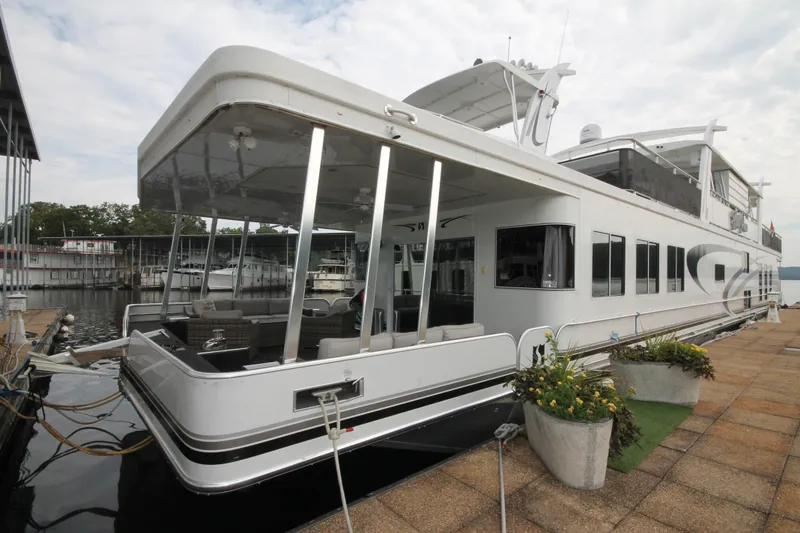 Slide: The Image of 2008 Sharpe 105 Custom Houseboat docked, featuring spacious deck and modern design. - 5