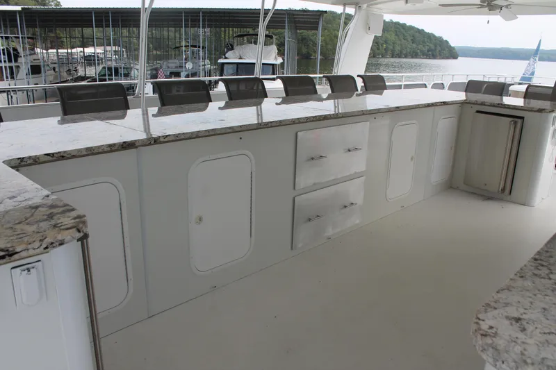 Slide: The Image of Outdoor kitchen on 2008 Sharpe 105 Custom Houseboat with granite countertops and storage cabinets. - 51