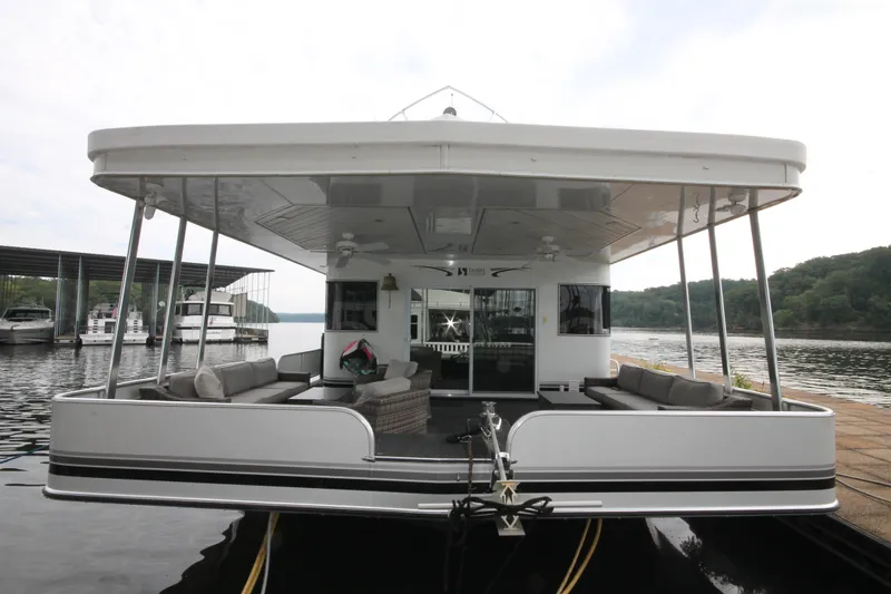 Slide: The Image of 2008 Sharpe 105 Custom Houseboat docked on a serene lake. - 6