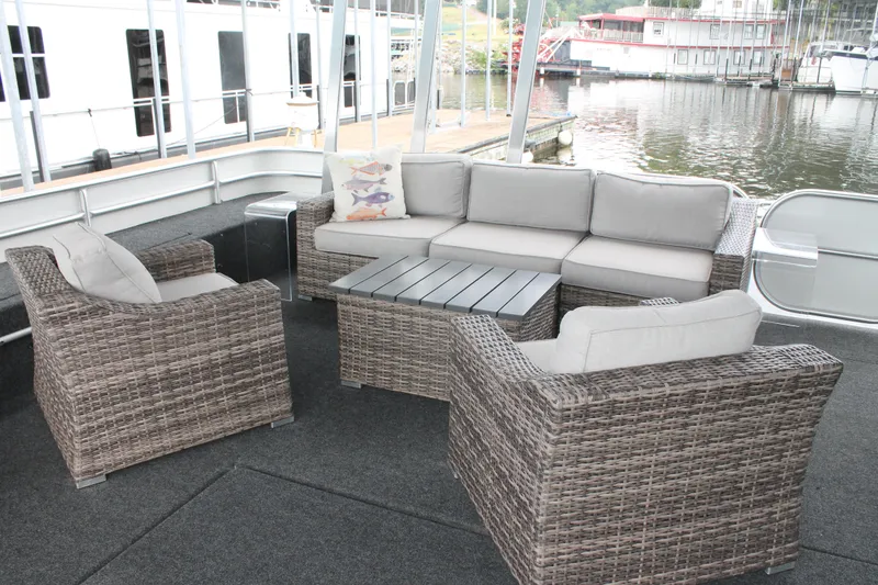 Slide: The Image of Outdoor seating area on 2008 Sharpe 105 Custom Houseboat, featuring wicker furniture and water view. - 9